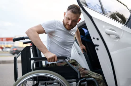 Person in a wheelchair getting in a van.